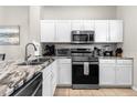 Modern kitchen with stainless steel appliances and granite countertops at 8558 Crystal Cove Loop, Kissimmee, FL 34747