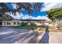 Ranch style home with mature trees and a large yard at 9000 Ogilvie Dr, Orlando, FL 32819