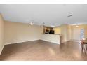Spacious living area with hardwood floors and a view into the kitchen at 10125 Shadow Leaf Ct, Orlando, FL 32825