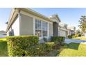 House exterior showcasing a large window and neatly trimmed hedges at 1130 Brant Pt, Orlando, FL 32828