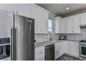 Modern kitchen with white cabinets and stainless steel appliances at 13648 Fresh Ivy St, Winter Garden, FL 34787