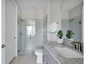 Bathroom with gray vanity, glass shower and granite countertop at 13714 Fresh Ivy St, Winter Garden, FL 34787