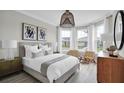 Bright bedroom with wood-look floors and large windows at 13714 Fresh Ivy St, Winter Garden, FL 34787