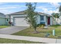 Front view of a single story house with a gray exterior and red front door at 2322 Twin Flower Ln, Sanford, FL 32771