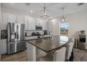 Modern kitchen with stainless steel appliances and a large kitchen island at 242 Aberdeen St, Davenport, FL 33896