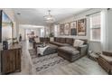 Inviting living room with a large sectional, neutral tones, and seamless flow to the dining area at 242 Aberdeen St, Davenport, FL 33896