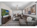 Spacious living room featuring a large sectional sofa and a flat-screen TV at 242 Aberdeen St, Davenport, FL 33896