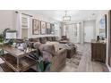 Spacious living room with modern decor, large sectional sofa, and ample natural light at 242 Aberdeen St, Davenport, FL 33896