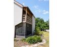 Exterior view featuring a screened porch, balcony, and lush landscaping on a sunny day at 242 Orienta Point St # 242, Altamonte Springs, FL 32701