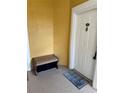 View of the front door with the address number and welcome mat, plus a bench at 3757 Conroy Rd # 2525, Orlando, FL 32839
