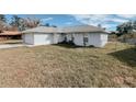 Light gray house with a white garage door and a large yard at 4465 Ne 2Nd Ct, Ocala, FL 34479