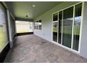 Covered outdoor patio featuring brick flooring, lots of space, and lots of light at 4535 Gliding Wave St, Winter Garden, FL 34787