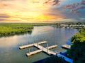 Community boat dock on calm waters at sunset, offering relaxing waterfront views at 5 Riverwalk Dr # 503, New Smyrna Beach, FL 32169