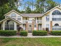 Charming condo building with a two story facade, well-manicured landscaping, and large arched windows at 5003 Laguna Bay Cir # 16, Kissimmee, FL 34746