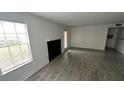 Living room with tile floors, fireplace and large windows at 5587 Devonbriar Way # 104, Orlando, FL 32822