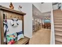 Bright and airy entryway with a wooden bench and staircase at 8857 Rhodes St, Kissimmee, FL 34747
