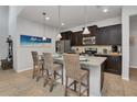 Modern kitchen with dark cabinets, granite counters and island at 8857 Rhodes St, Kissimmee, FL 34747