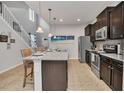 Modern kitchen with dark cabinets, granite counters and island at 8857 Rhodes St, Kissimmee, FL 34747