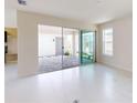 Open-concept living area with a large sliding door opening to the patio for seamless indoor-outdoor flow at 9819 Gobat Aly, Orlando, FL 32827