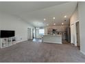 Open living room with high ceilings and neutral color palette at 1107 Tropea Ln, Auburndale, FL 33823