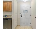 Interior entryway with kitchen cabinets and door at 12556 Floridays Resort Dr # 206A, Orlando, FL 32821