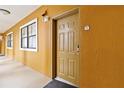 Condo entry with a yellow wall and door at 12556 Floridays Resort Dr # 206A, Orlando, FL 32821