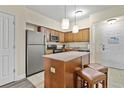 Modern kitchen with island and stainless steel appliances at 12556 Floridays Resort Dr # 206A, Orlando, FL 32821