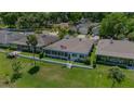 Aerial view of a charming home with a large, well-maintained backyard, surrounded by lush greenery at 1433 Lake Marion Dr, Apopka, FL 32712