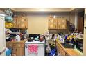 Small condo kitchen with wood cabinets and appliances at 197 Scottsdale Sq # 197, Winter Park, FL 32792