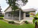 Screened porch with seating area and backyard view at 2530 Saffron Ln, The Villages, FL 32162