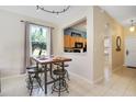 Casual dining area with a kitchen pass-through and a rustic wooden table at 2740 Coupe St, Kissimmee, FL 34746