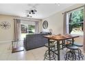 Living room with a gray sofa, glass coffee table, and access to the backyard at 2740 Coupe St, Kissimmee, FL 34746