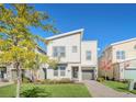 Modern two-story house with light beige siding, gray roof and a landscaped front yard at 2748 Bookmark Dr, Kissimmee, FL 34746