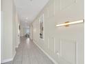 Bright hallway with tile flooring, recessed lighting and decorative wall at 2748 Bookmark Dr, Kissimmee, FL 34746