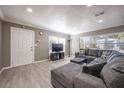 Cozy living room with large windows, a comfortable gray sectional, and neutral decor at 2803 E Pine St, Orlando, FL 32803