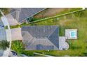 An aerial view shows the house with a backyard pool and solar panels on the roof at 4032 Prairie Reserve Blvd, Orlando, FL 32824