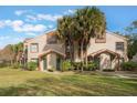 Front view of condo building, showing landscaping and entryways at 5436 E Michigan St # 4, Orlando, FL 32812