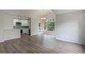 Open concept living space with modern kitchen and wood-look floors at 5436 E Michigan St # 4, Orlando, FL 32812