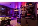 Game room with pool table, air hockey, basketball game, and vibrant lighting at 6080 High Seas Dr, Orlando, FL 32821