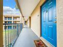 Apartment building hallway with blue door and courtyard view at 7350 Westpointe Blvd # 224, Orlando, FL 32835