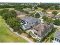 Beautiful aerial view of home showcasing the backyard pool, outdoor seating, and well-maintained landscaping at 7399 Gathering Ct, Reunion, FL 34747