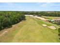Scenic view of the lush green golf course adjacent to the property, offering a serene and picturesque backdrop at 7399 Gathering Ct, Reunion, FL 34747