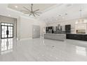 Modern kitchen with marble floors, stainless steel appliances, and a large center island, perfect for entertaining at 7399 Gathering Ct, Reunion, FL 34747