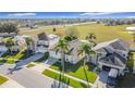 Aerial view of a residential neighborhood with houses and palm trees at 8030 King Palm Cir, Kissimmee, FL 34747