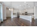 Spacious kitchen with an island, stainless steel appliances, and dark hardwood floors at 8763 Laureate Blvd, Orlando, FL 32827