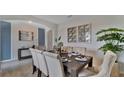 Elegant dining room with a dark wood table and neutral chairs at 1261 Limbali St, Mount Dora, FL 32757