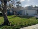 Front yard view of charming house with lush green grass at 2122 King Richards Ct, Orange City, FL 32763