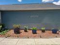 Exterior of home showcasing flower bed in front of the home with mulch at 2122 King Richards Ct, Orange City, FL 32763