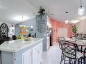 Open kitchen featuring a center island with pendant lighting and a view of the breakfast nook at 2122 King Richards Ct, Orange City, FL 32763