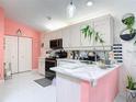 Clean kitchen design with white cabinets, stainless steel appliances and decorative accents at 2122 King Richards Ct, Orange City, FL 32763